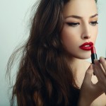 women applying lipstick