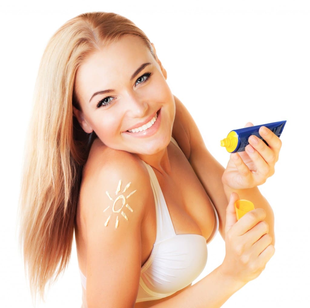 Beautiful woman using sunscreen