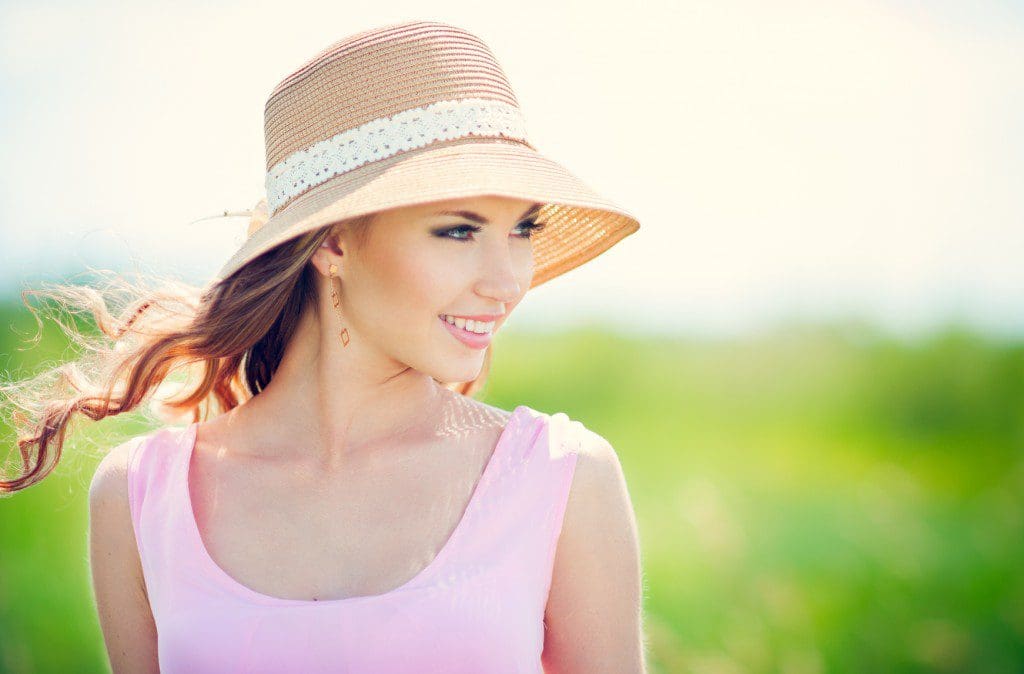 Beautiful happy smiling woman on summer meadow