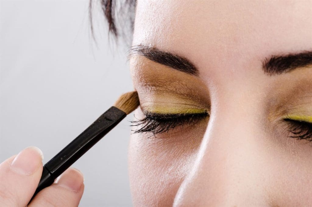 Beautician artist applying makeup