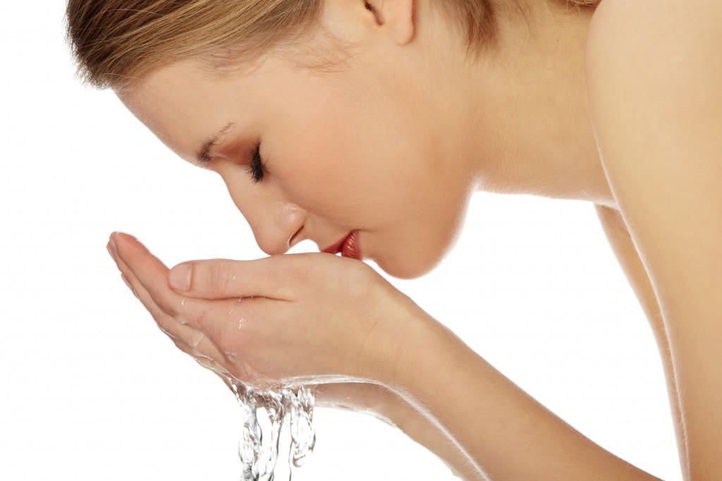 Young female washing her face