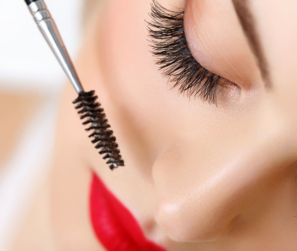 Woman eye with beautiful makeup and long eyelashes. Mascara Brus