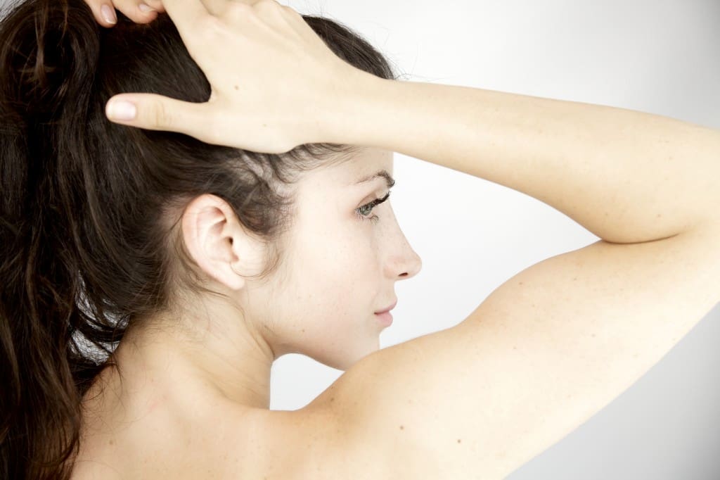 Image of purity of woman holding hair in ponytail