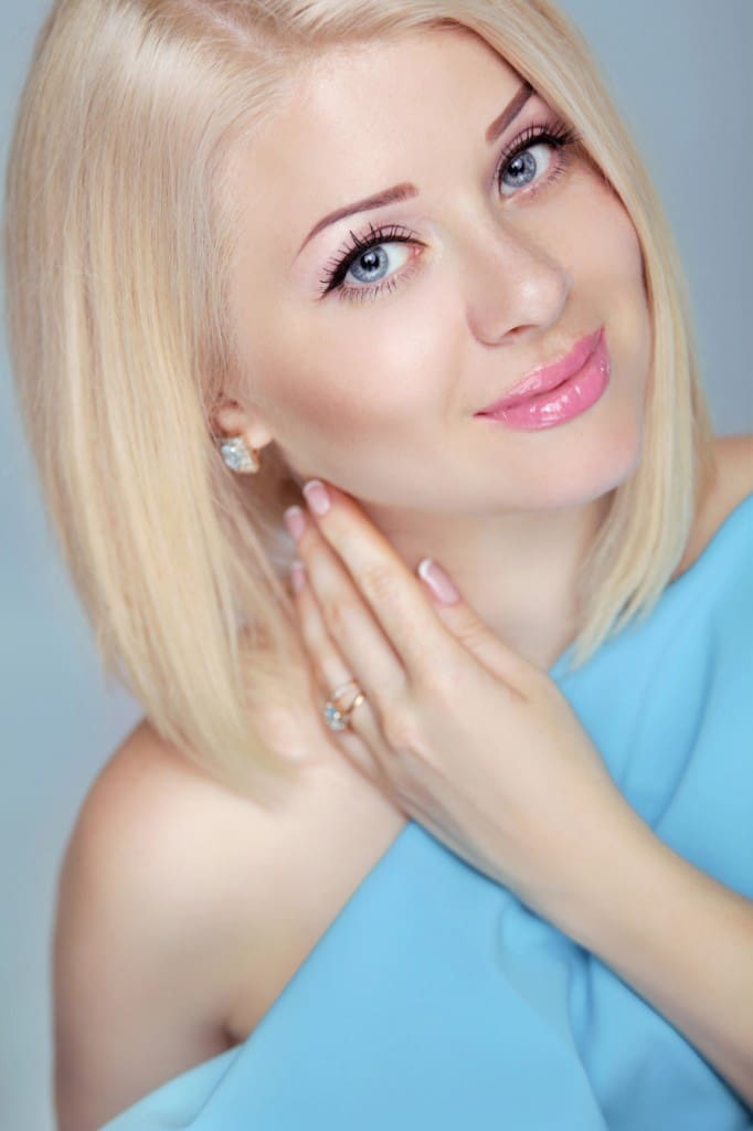 Pretty Beautiful blonde woman with short hair styling. Eyes make
