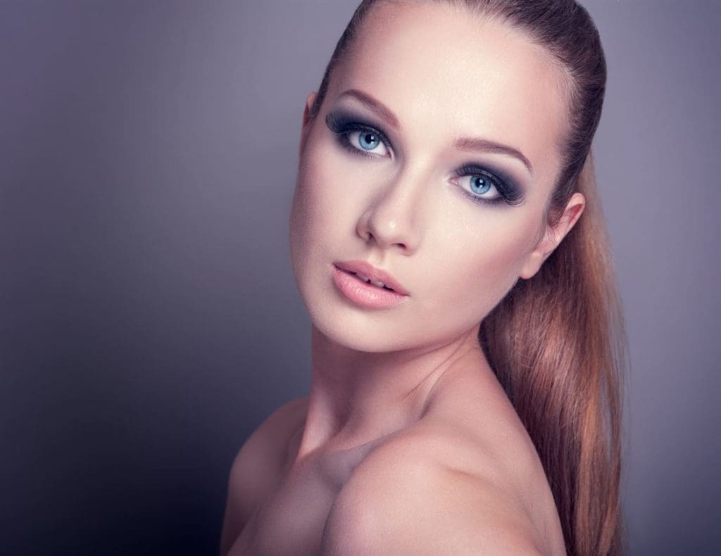 beautiful woman on a dark background with smoky eye makeup